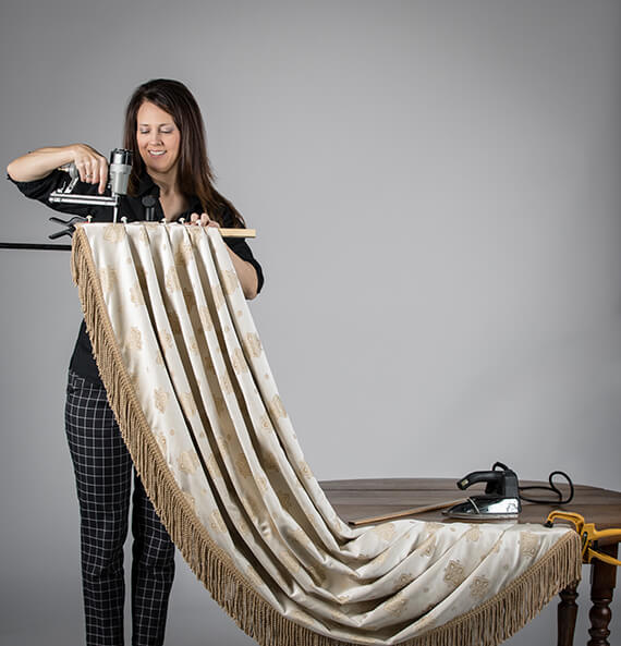 Interior designer Linda Tully ironing drapes.